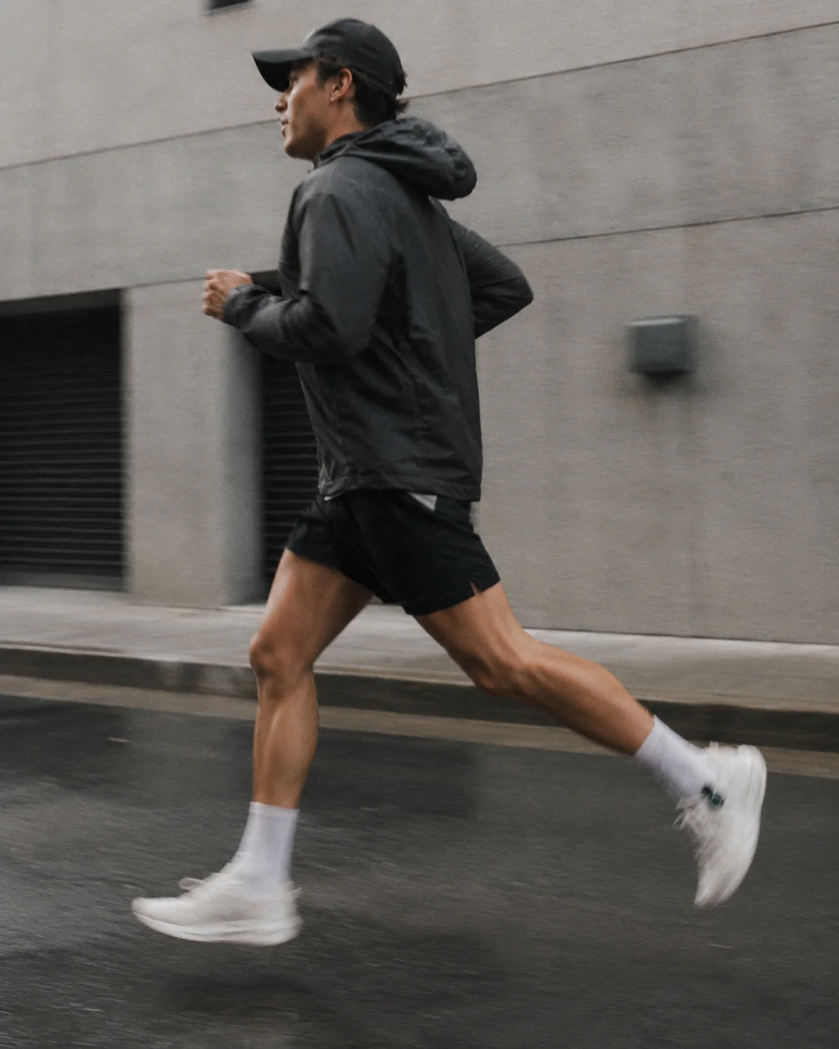 Runner wearing STRIV on a wet street