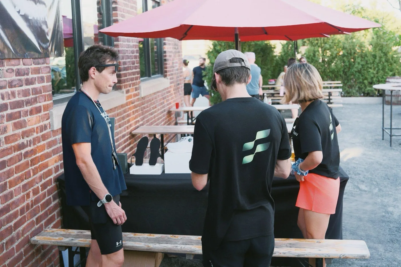 Runners trying STRIV at a community demo table
